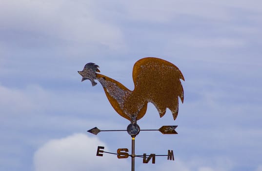 
Weather vane-cock of metal, with arrows showing the direction of the light.