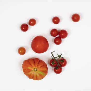 some types of tomatoes on a white surface