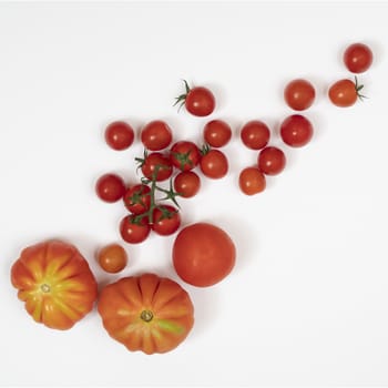 some types of tomatoes on a white surface