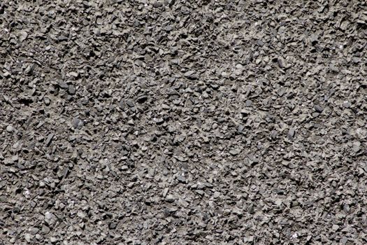 The wall consists of stone chips of dark color on a flat surface.