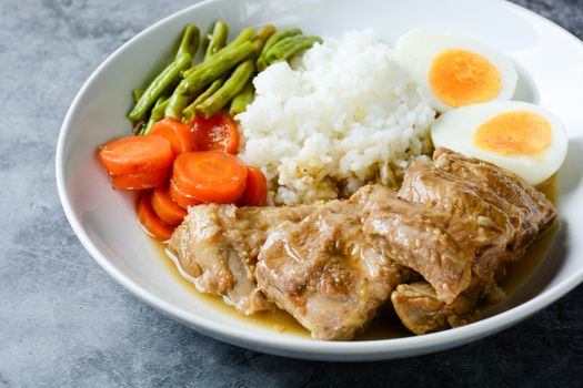 Baked pork ribs with rice, boiled egg and vegetable