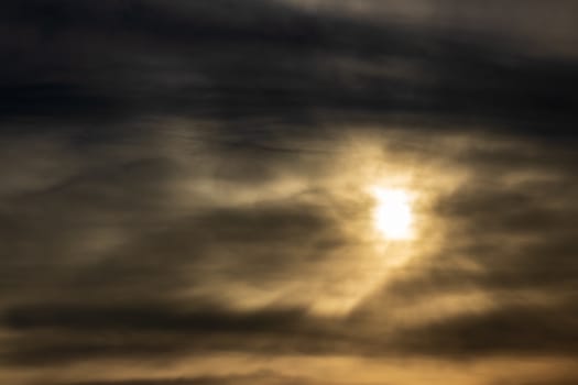 a skyscape shoot of golden sun with intense clouds. colors are interesting.