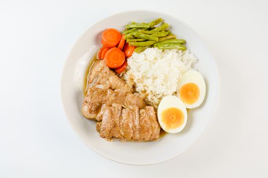 Baked pork ribs with rice, boiled egg and vegetable