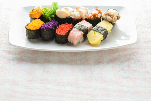 Sushi on white plate, tuna, salmon, sea bass, sweet egg, shrimp sushi, Japanese food
