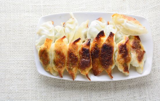 Japanese Fried Dumplings, the half moon-shaped dumplings served in Asian restaurants as an appetiser or side dish, pork and vegetable filling.
