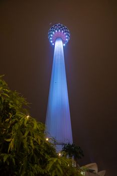 Blue illuminated big transmission tower in Kuala Lumpur