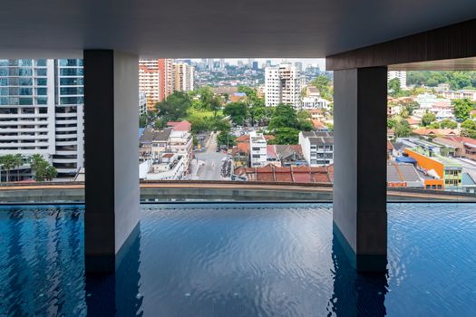 Highrise sky pool in front of small houses in Kuala Lumpur