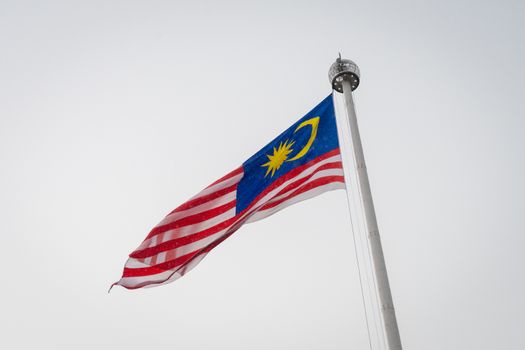 Malaysian national flag on huge flag pole during heavy rain