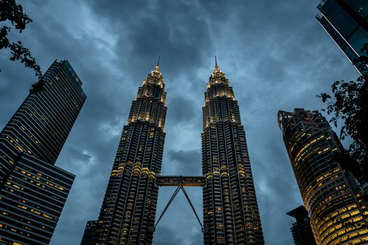 Petronas twin towers illuminated during blue hour in Kuala Lumpur