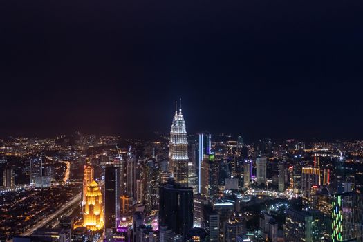 Skyline of Kuala Lumpur during nighttime over viewing illuminated highrise building