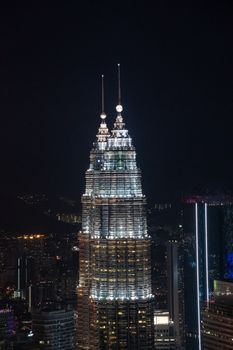 Twin towers in Kuala Lumpur during nigh over viewing illuminated highrise building