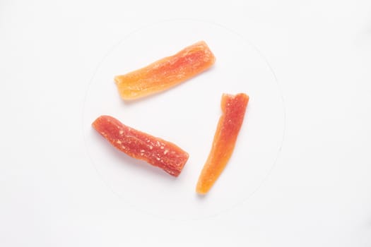 Candied papaya sticks pieces isolated on white backgroud. 