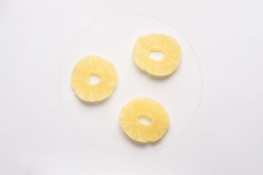 Candied pineapple round chips isolated on white backgroud. 