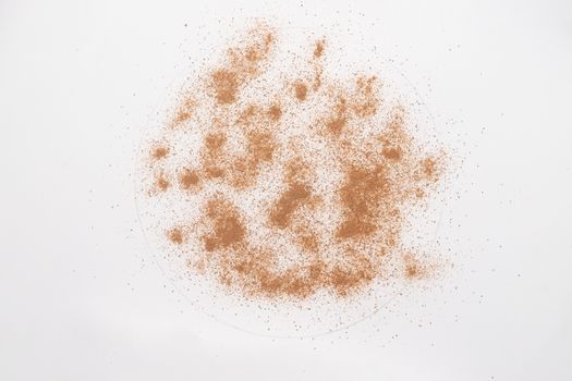 Ground cinnamon powder isolated on white backgroud. 