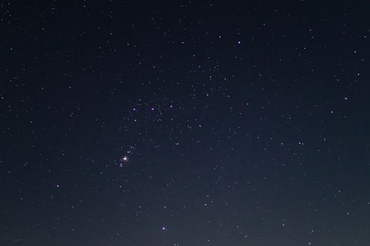 Night sky low light photo. A lot of stars and constellations on dark sky. Stock photo of deep sky. Far away from city and no clouds.