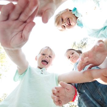 Group of smiling children looking down into camera