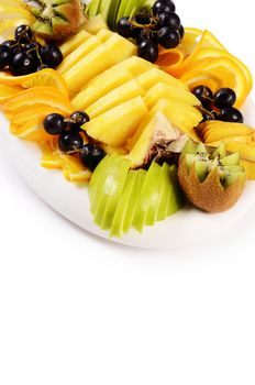 Slicing fruit with pineapple, orange and grapes