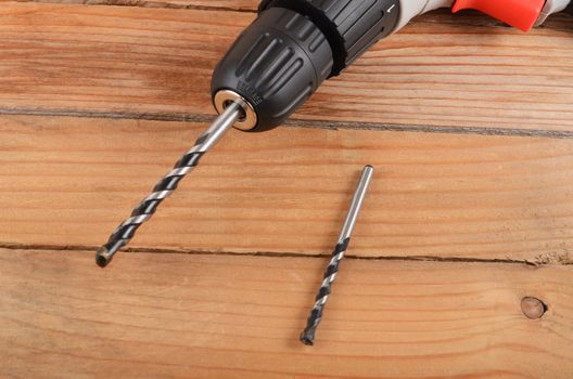 The new electric drill on wooden background