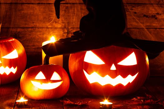 Jack O Lantern Halloween pumpkin with witches hat and burning candles