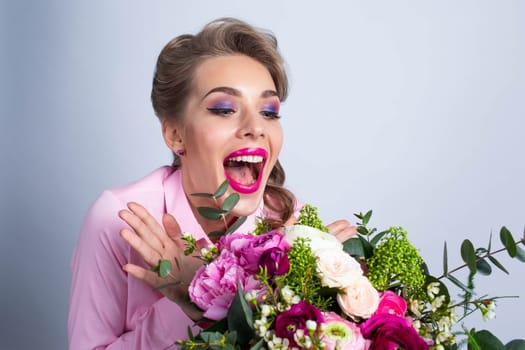 Young beautiful woman look at bouquet of flowers very happy and excited screaming in joy