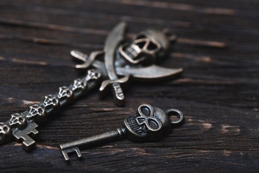 Vintage skull skeleton keys on a wooden table. Close-up view