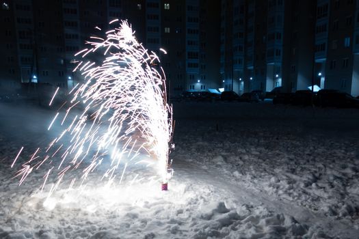 Burning Mini Fireworks in the Snow on a Winter Evening.