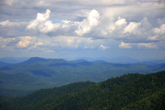 Mountain landscape under the clouds from a bird's eye view. Altai, Siberia, Russia.