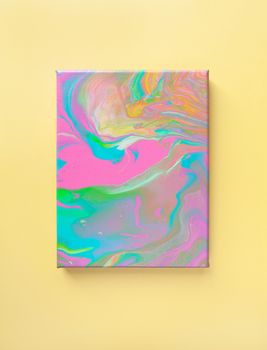 Painting in bright pastel colors on wall using liquid fluid art trendy technique. Central composition. View opposite. Flat lay. Close-up. Concept contemporary art accessible to everyone.