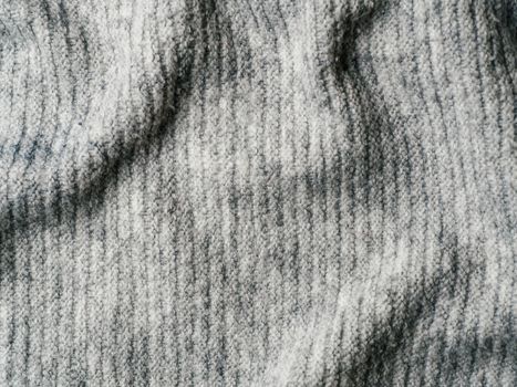 Gray sweater fabric texture. Clothes sweater background with folds