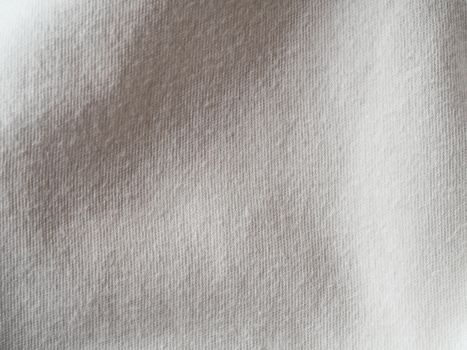 White cotton fabric texture. Clothes cotton jersey background with folds