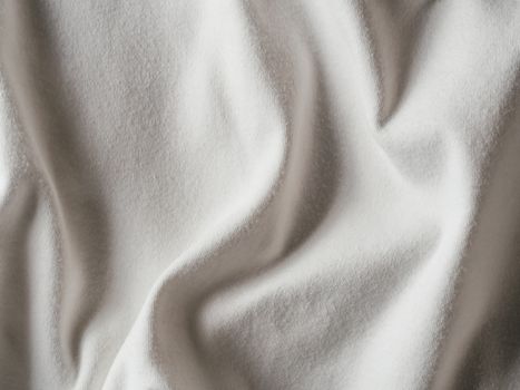 White cotton fabric texture. Clothes cotton jersey background with folds