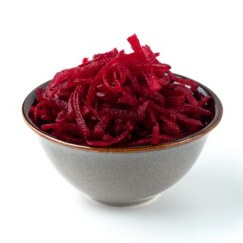 Grated beetroot in ceramic bowl. Shredded beet root salad isolated on white