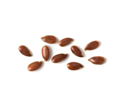 Extreme close up of flax seeds isolated on white background. Linseed pile closeup isolated on white with clipping path. Top view or flat lay. Macro shot