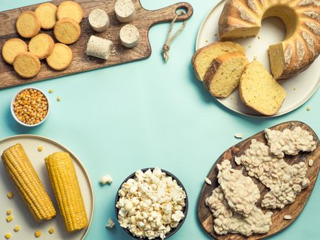 Festa Junina traditional food background,copy space for text. Delicious sweets for Brazilian Festa Junina Party: cornmeal cake Bolo de Fuba, corn cookies,popcorn,peanut candy Pacoca, corn ear top view