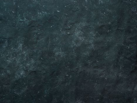 Dark mottled rustic background. Black blue canvas backdrop for design. Natural linen colored black blue dirty canvas fabric background or texture.