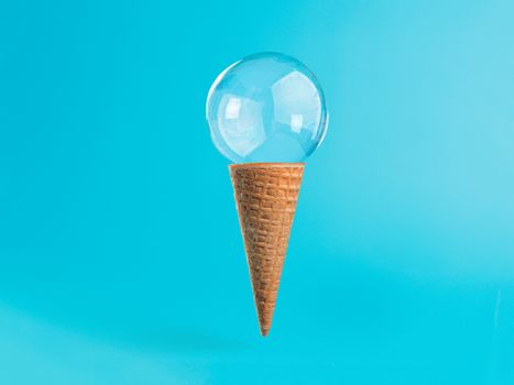 Ice cream cone with soap bubble. Creative layout ice cream in air over blue background. Soap bubble ice cream on brigt blue background. Semi flat style. Minimal summer concept