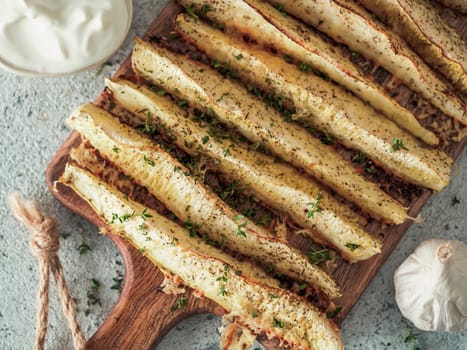 Baked Parmesan Garlic Zucchini. Ideas and recipes for easy and healthy lunch or dinner - oven baked zucchini. Top view or flat lay.