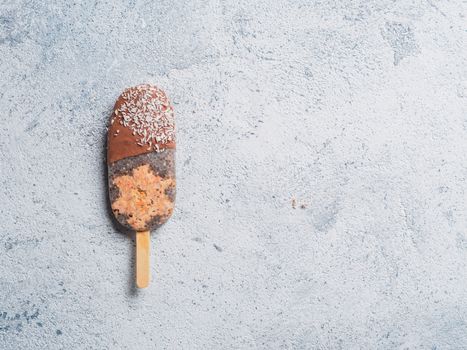 Chia popsicle with raw carrot cake and chocolate on gray background. Healthy recipe and idea homemade vegan popsicle ice cream. Easter dessert idea. Copy space for text. Top view or flat-lay.