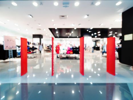 Shopping mall blur background with bokeh. Abstract blurred entrance area of clothes and shoes store. Copy space