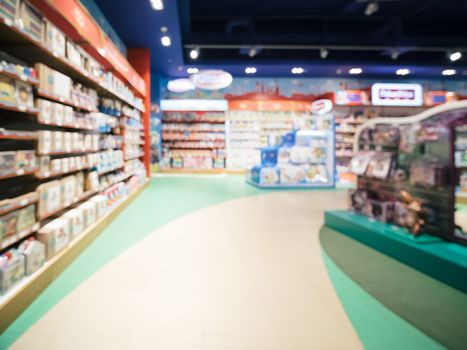 Blurred of kids toy store background with bokhe. Purple and yellow colors of toys shop interior, copy space