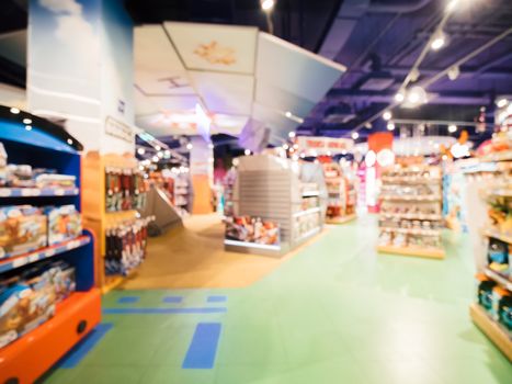 Blurred of kids toy store background with bokhe. Purple and yellow colors of toys shop interior, copy space