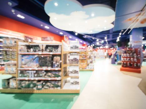 Blurred of kids toy store background with bokhe. Purple and yellow colors of toys shop interior, copy space
