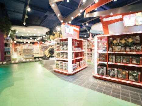 Blurred of kids toy store background with bokhe. Purple and yellow colors of toys shop interior, copy space