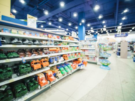 Blurred of kids toy store background with bokhe. shelves with cars and aisle of kids toy shop interior, copy space