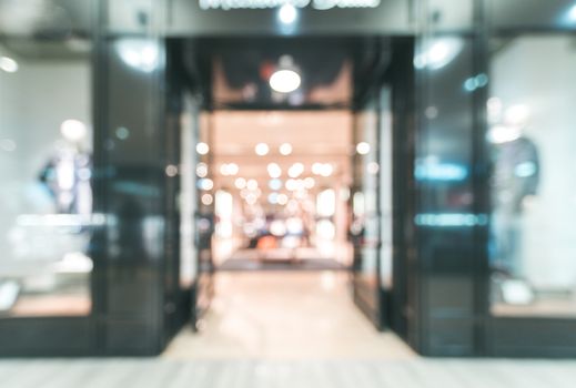 Shopping mall blur background with bokeh. Blurred hall of shopping mall with customers as background. Copy space