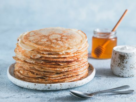 Stack of traditional russian pancakes blini on gray background with copy space. Homemade russian thin pancakes blini. Russian food, russian kitchen