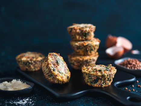 Buckwheat casserole with spinach,carrot,parmesan cheese.Baked eggs with buckwheat,vegetables and cheese.Ideas and recipes healthy easy breakfast,lunch,kids meal,snack - vegetables muffins.Copy space
