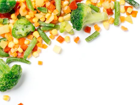 Frozen vegetables assorted isolated on white with clipping path. Frosen vegetables with ice Isolated one edge. Frozen mix vegetables with copy space for text. Top view or flat-lay.
