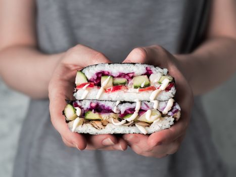 Vegan sushi sandwich onigirazu with mushrooms and vegetables.Healthy dinner recipe and idea. Colorful japan big roll sandwich onigirazu with red cabbage,radish,cucumber,mushrooms.Trend food.Copy space