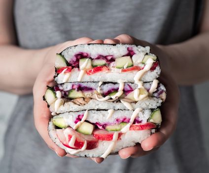 Vegan sushi sandwich onigirazu with mushrooms and vegetables.Healthy dinner recipe and idea. Colorful japan big roll sandwich onigirazu with red cabbage,radish,cucumber,mushrooms.Trend food.Copy space